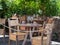 Empty Wooden Tables with Crystal Wine tasting Glasses Set for Outdoor Lunch in a Tuscan Village in Italy