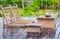 Empty wooden terrace with lounge beds and table. Wooden patio after rain. Wet terrace in tropical resort.