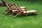 Empty Wooden Weathered Lounger On The Lawn At The Evening
