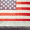 Empty wooden white table over USA flag bokeh background. USA national holidays background. 4th of July celebration.