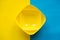 Empty yellow bowls on on blue and yellow background. Plastic utensils for the kitchen. Top view. Minimalist Style. Copy, empty