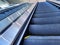 Empty, yellow lined escalator steps inside a building