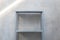 empty zinc shelf with concrete wall background