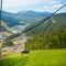 Emtpy chairlift in ski resort. Mountains and hills with in Summer with green trees