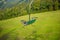 Emtpy chairlift in ski resort. Mountains and hills with in Summer with green trees