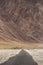 Emty road vanishing into HImalayas mountains in Ladakh, Northern India