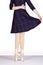 En Pointe CORRECT heels together hand on waist and holding blue tartan dress out