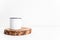 Enamel white mug on rustic wooden cut section mockup. Boho style classic stock photo. Still life composition with white metal mug