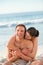 Enamored couple hugging on the beach