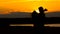 Enamored girl and the guy on the beach embracing at sunset