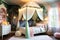 Enchanted Child\\\'s Bedroom: Canopy Bed Draped in Twinkling Fairy Lights, Walls Adorned with Murals of Whimsy