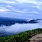 Enchanting blue sky with white clouds at the top and rising from the earth