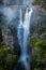 Enchanting Carrington Falls with wind blowing spray off waterfall