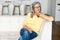 Enchanting middle-aged woman sits on the couch and relaxing