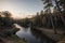 Enchanting Twilight Forest River and Sunset Painting the Sky.AI Generated