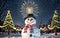 Enchanting Winter Snowman\\\'s Glow Amongst Pine Trees and Warm Light