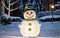 Enchanting Winter Snowman\\\'s Glow Amongst Pine Trees and Warm Light