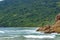 The encounter between the beach, preserved tropical forest and the sea in Trindade