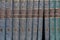 Encyclopedia in five volumes stacked vertically on the bookshelves, photo illustration