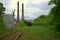 The end of an abandoned railway line of old cars and pipes of an abandoned factory. Landdscape