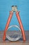 End cutter pliers with red plastic handles and steel wire.