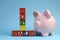 End of Financial Year sale message on building blocks with piggy bank