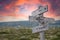 end limit boundary text engraved in wooden signpost outdoors in nature during sunset