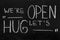 End of quarantine.Chalkboard text message We`re open, let`s hug