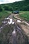 End of the road. Crossover on dirt countyside road. dust and trash. after rain, off road car. vertical photo, navigation lost