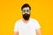 Endearing geekiness. Bearded man yellow background. Serious man wear glasses in hipster style. Caucasian man with