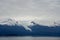 Endicott Arm, Alaska, USA: Snow-capped mountains under a cloudy sky in the Endicott Arm
