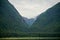 Endicott Arm, Alaska, USA: A tree-lined valley under a cloudy sky