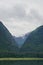 Endicott Arm, Alaska, USA: A tree-lined valley under a cloudy sky