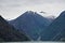 Endicott Arm, Alaska: A waterfall flows into the bright green glacial waters