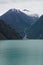 Endicott Arm, Alaska: A waterfall flows into the bright green glacial waters