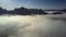 Endless aerial panorama mountains protrude from white fog