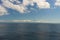 The endless clear blue sea and the blue sky with white clouds merge on the horizon. Seascape. Natural background