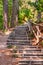 Endless curved wooden logs steps with crossed logs railings in the forest of Numana surroundings in Italy