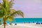 An endless deserted beach with palm trees and white sand and a number of lounge chairs for relaxation. paradise vacation. Florida.