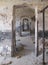 Endless doors in vintage old ruined building with damaged plaster walls