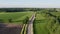 Endless greens: aerial view of road amidst spring fields