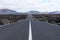 Endless highway through the volcanic landscape. Lanzarote. Canary islands