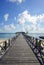 Endless jetty to the horizon; view to a turquoise sea and blue s