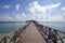 Endless jetty to the horizon; view to a turquoise sea and blue s