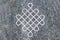 Endless knot engraved on stone surface.