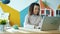 Endless loop of Afro-American woman working with laptop while steam rising from coffee cup in office