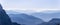 Endless mountain ranges of the Dolomites covered in morning mist. View from Seiser Alm plateau