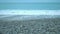 Endless ocean, foamy waves washing up on clean pebble beach, nature conservation