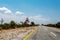 Endless road with blue sky and sign elephants crossing