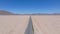 Endless road to horizon through the desert valley. Aerial view of a desert.